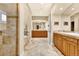 Elegant bathroom featuring marble floors, countertops, shower, tub, and well-crafted wooden vanities at 100 S University Blvd # 4, Denver, CO 80209