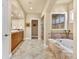 Elegant bathroom with a soaking tub, large vanity, marble tile, and a separate shower, offering a luxurious retreat at 100 S University Blvd # 4, Denver, CO 80209