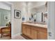 Bathroom featuring a dual sink vanity, framed mirror and decorative towels at 100 S University Blvd # 4, Denver, CO 80209