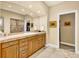 Luxurious bathroom featuring wood cabinets, marble tile flooring, large mirrors, and a walk-in closet at 100 S University Blvd # 4, Denver, CO 80209