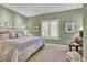 Comfortable bedroom with natural light, carpet flooring and soft green walls at 100 S University Blvd # 4, Denver, CO 80209