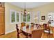 Bright dining area featuring a wooden table, chairs, decorative chandelier, and natural light from multiple windows at 100 S University Blvd # 4, Denver, CO 80209