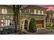 Charming home featuring a gated entrance, a wooden garage door, and lush greenery at 100 S University Blvd # 4, Denver, CO 80209