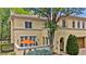 Elegant, light yellow two-story home with a tile roof, trimmed windows, and an orange umbrella on a small patio at 100 S University Blvd # 4, Denver, CO 80209