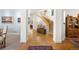 Elegant foyer with hardwood floors, staircase, and views into the living spaces at 100 S University Blvd # 4, Denver, CO 80209