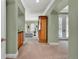 Hallway with arches leading to a living area, featuring carpeted floors, built-in cabinets and plenty of natural light at 100 S University Blvd # 4, Denver, CO 80209