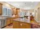 Spacious kitchen with a large granite island, wood cabinets, stainless steel appliances, and a breakfast nook at 100 S University Blvd # 4, Denver, CO 80209