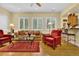 Bright living room with large windows, comfortable seating, and hardwood flooring at 100 S University Blvd # 4, Denver, CO 80209