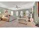 Spacious main bedroom with a fireplace, lounge area, elegant decor, and multiple windows for natural light at 100 S University Blvd # 4, Denver, CO 80209