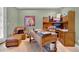 Cozy office space with a large desk, leather chair, and custom shelving, creating an ideal workspace at 100 S University Blvd # 4, Denver, CO 80209
