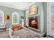 Sitting area with a cozy fireplace, comfortable seating, and arched windows at 100 S University Blvd # 4, Denver, CO 80209