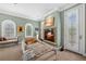 Cozy sitting area with a fireplace, comfortable chairs, and natural light from arched windows at 100 S University Blvd # 4, Denver, CO 80209