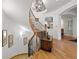 Curving staircase with hardwood floors, iron railings, a decorative chest, and elegant lighting at 100 S University Blvd # 4, Denver, CO 80209