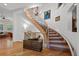 Elegant staircase with wood and iron railings, chandelier, and decorative accents at 100 S University Blvd # 4, Denver, CO 80209