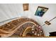 Grand spiral staircase with wooden railings, carpeted steps, wrought iron spindles, and elegant lighting at 100 S University Blvd # 4, Denver, CO 80209