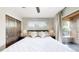 Bright bedroom featuring a sliding wood door, ceiling fan, and access to outdoor patio area at 1426 S Pearl St, Denver, CO 80210