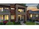Modern two-story home with a stone and wood facade, a balcony, and manicured landscaping at 1426 S Pearl St, Denver, CO 80210