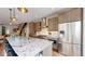 Contemporary kitchen featuring a large island with granite countertops and stainless steel appliances at 1426 S Pearl St, Denver, CO 80210