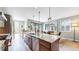 Bright kitchen with stainless steel appliances, a center island, and an adjacent dining area at 1426 S Pearl St, Denver, CO 80210