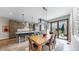 Modern kitchen with stainless steel appliances, a center island, and an adjacent dining area at 1426 S Pearl St, Denver, CO 80210