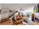 Bright, open living room with hardwood floors, a fireplace, and access to the dining area at 1426 S Pearl St, Denver, CO 80210