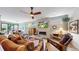 Comfortable living room with fireplace, ceiling fan, and dining area in the background at 1426 S Pearl St, Denver, CO 80210