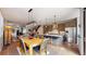 Bright, open-concept living space featuring a modern kitchen, dining area, and cozy living room with hardwood floors at 1426 S Pearl St, Denver, CO 80210