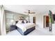 Relaxing main bedroom with a ceiling fan, bedside table and a large bed that is topped with plush pillows at 1426 S Pearl St, Denver, CO 80210