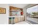 Stylish wet bar with a beverage fridge, modern sink, shelving, and access to a patio at 1426 S Pearl St, Denver, CO 80210