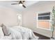 Bedroom with neutral walls, wood floors, ceiling fan, and good light at 1469 S Lincoln St, Denver, CO 80210