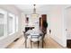Bright dining room featuring modern light fixture, table with seating for six, and wood floors at 1469 S Lincoln St, Denver, CO 80210