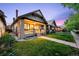 Quaint home showing the front exterior, a charming porch, and a lush green lawn during twilight at 1469 S Lincoln St, Denver, CO 80210