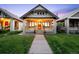 Charming bungalow with front porch, flowers, walkway and nicely manicured lawn at 1469 S Lincoln St, Denver, CO 80210