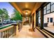 Inviting front porch, natural light with neighborhood views and shade from the trees at 1469 S Lincoln St, Denver, CO 80210
