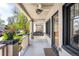 Inviting front porch with a ceiling fan and hanging swing, perfect for relaxing outdoors at 1469 S Lincoln St, Denver, CO 80210