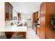 Spacious kitchen with stainless steel appliances, wooden cabinets, tile floors, and a breakfast bar at 1469 S Lincoln St, Denver, CO 80210