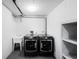 Laundry room featuring modern washer and dryer, laundry sink, and white shelving at 1469 S Lincoln St, Denver, CO 80210