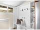 Mud room with bench and storage hooks, next to the laundry and with window at 1469 S Lincoln St, Denver, CO 80210