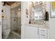 Modern bathroom with marble shower and mosaic tile floor at 2 Adams St # 1010, Denver, CO 80206