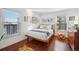 Cozy bedroom with wood floors and large windows at 2 Adams St # 1010, Denver, CO 80206