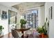 Sunlit dining room with a round table and city views at 2 Adams St # 1010, Denver, CO 80206