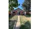 Backyard view of red house with sliding glass doors and fenced yard at 3036 W Clyde Pl, Denver, CO 80211