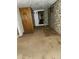 Unfinished basement with unique wallpaper and access to a toilet at 3036 W Clyde Pl, Denver, CO 80211