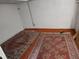 Unfinished basement featuring decorative carpets on orange flooring at 3036 W Clyde Pl, Denver, CO 80211
