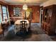 Classic dining room with vintage chandelier, decorative furnishings, and adjacent kitchen view at 3036 W Clyde Pl, Denver, CO 80211