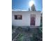 View of shed with weathered door, window, and natural surroundings at 3036 W Clyde Pl, Denver, CO 80211