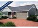 Charming one story home featuring an attached two car garage and a brick paver driveway at 21897 E 51St Dr, Aurora, CO 80019