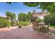 Serene backyard featuring a brick patio with a dining table and lush landscaping at 3752 S Helena Way, Aurora, CO 80013