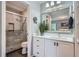Bathroom features a modern vanity, large mirror, and a glass-enclosed shower at 3752 S Helena Way, Aurora, CO 80013