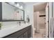 Bathroom featuring a grey vanity and an additional bathroom through an open doorway at 3752 S Helena Way, Aurora, CO 80013